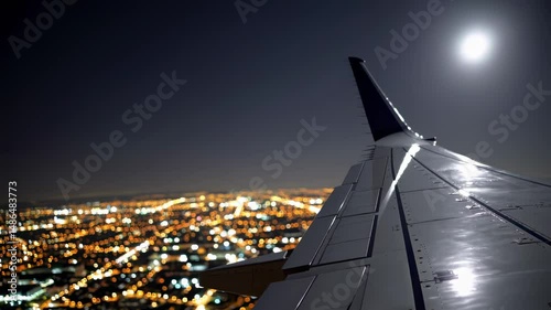Plane wing in moonlight over illuminated city conveys travel ambition freedom horizon journey progress dreaming exploring opportunity