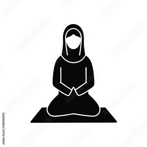 Muslim woman praying in traditional attire