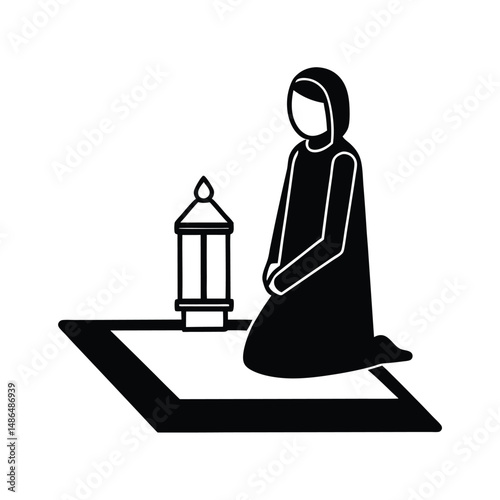 Muslim woman praying on prayer mat with lantern