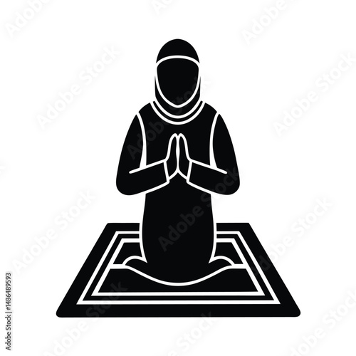 Muslim woman praying on prayer mat islamic faith
