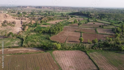 Drone Aerial View of Agricultural Farmland Before Crop Plantation with Straight Machine-Made Lines in the Field Showing Preparation for Sowing in Daylight