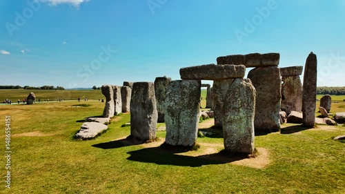 Iconic sarsen pillars arranged in a perfect circle on grassy plains under open sky at Stonehenge, Salisbury, Wiltshire, England, UK
