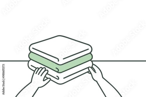 Hands stacking neatly folded towels on a flat surface 