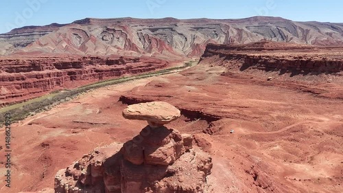 Aerial Flyover of Mexican Hat Rock Formation in Utah Desert