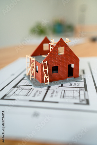Concept of building and projecting your own home. Vertical shot.