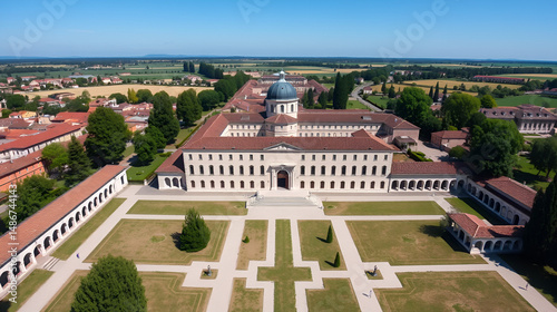 Aerial shot of the Certosa di Pavia at sunny day, built in the late fourteenth century, courts and the cloister of the monastery and shrine in the province of Pavia, Lombardia, Italy