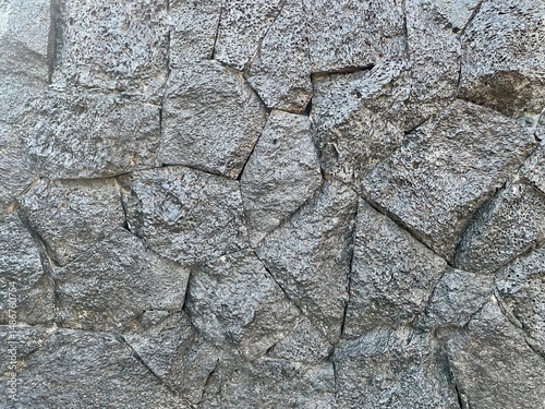 Rough gray broken stone wall background