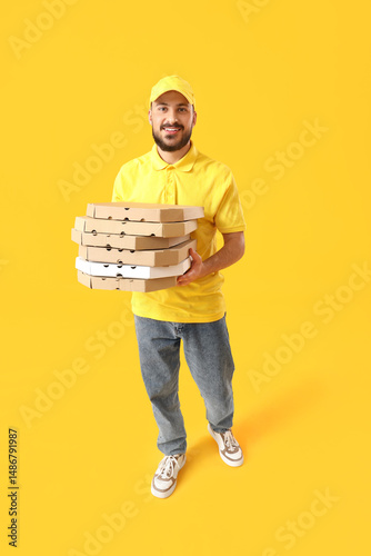 Male courier with many pizz...