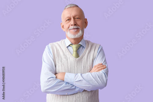 Happy senior man on lilac b...