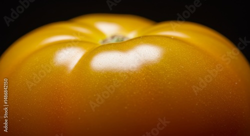 Intimate close-up of a vibrant yellow tomato highlighting its unique texture