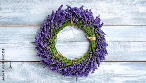 A lavender wreath on a white wooden surface in a top down close up view