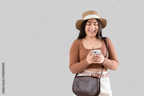 Young woman in hat using mo...