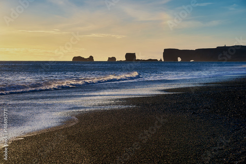 Black sand beach with ocean wave in sunset skyline , Seascape for landmark of icdland travel.
