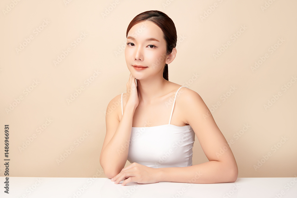 A beautiful young Asian woman with clean, fresh skin against a beige background. Skincare, facial treatment, cosmetology, beauty, and spa. An elegant portrait of an Asian woman. A beautiful young Asian woman with clean, fresh skin against a beige background. Skincare, facial treatment, cosmetology, beauty, and spa. An elegant portrait of an Asian woman.