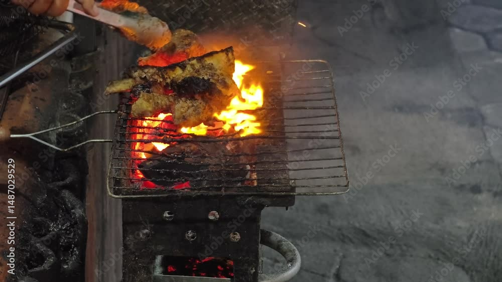 Grilled beef ribs on a blazing grill.