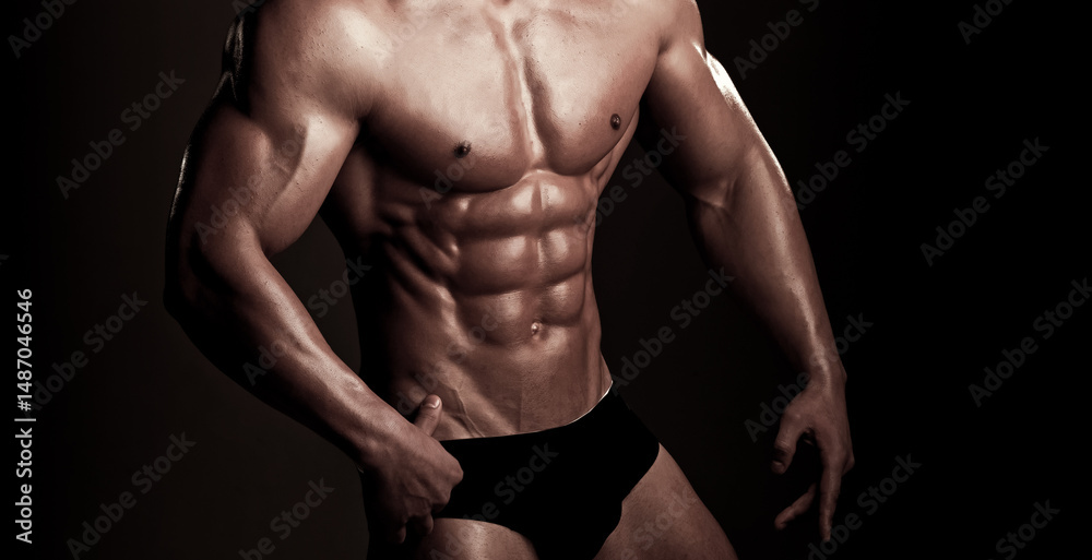Fototapeta premium Naked muscular torso, strong six pack, fit abs. Athletic sexy male body with six pack. Muscular six pack, bare torso. Fit guy with muscular abs. Muscular shirtless man model showing six pack abs.