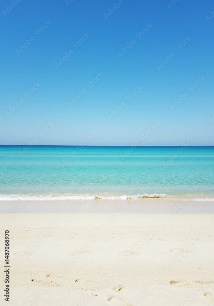 Fototapeta premium Tranquil Beach Scene: Azure Ocean Meets White Sand Under a Clear Blue Sky
