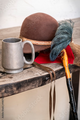 Feathered hat with a metal cup