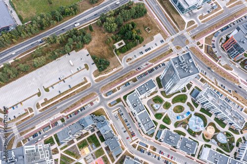 aerial top view of city residential area with multistory houses, streets, parking lot. drone photo on summer day.