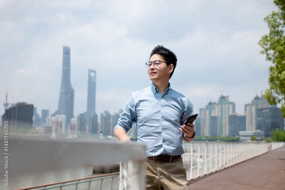 asian businessman using smart phone in city asian businessman using smart phone in city