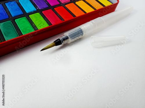 a water brush with watercolor paint on white background