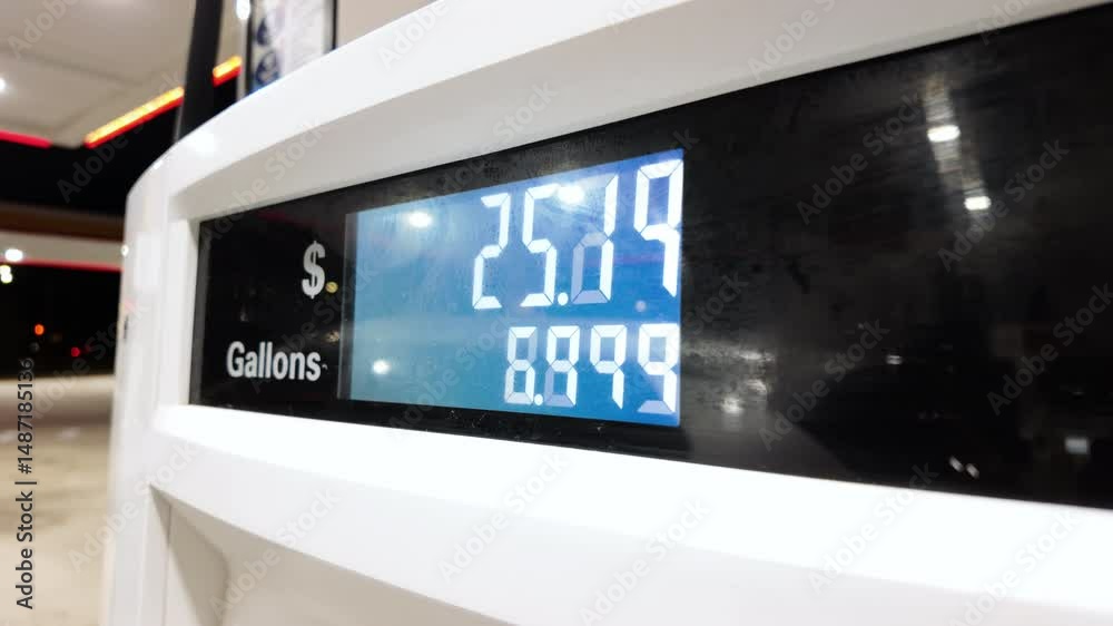 Petrol station with running numbers on gas pump at night time. Close up shot 
