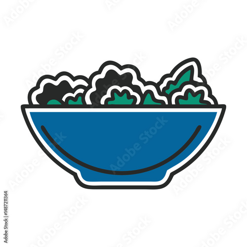Colorful salad bowl filled with fresh greens in a blue design  