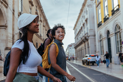 Tourists walking down street in lisbon, portugal, exploring city center