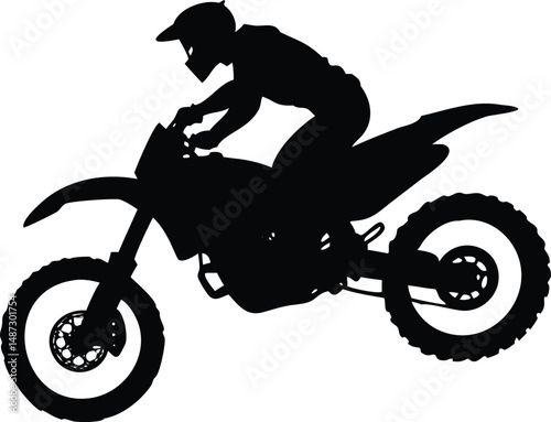 Silhouette shows a motorcyclist riding a motocross bike with precision and skill