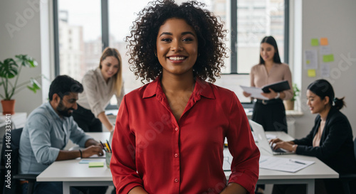 Smiling woman in a red shirt looking at the camera.
