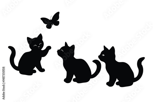 Playful black cat reaches for a butterfly while two cats are curiously observing