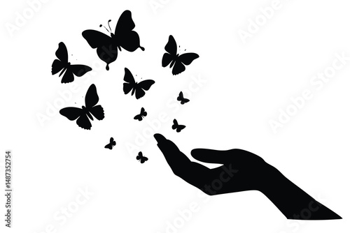 Silhouette hand releasing beautiful butterflies represents freedom and new beginnings in black and white