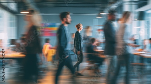 Busy Office Environment with Professionals Engaged in Work and a Woman Walking Through a Dynamic Workplace Scene