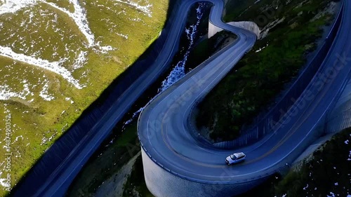 Aerial View of a Winding Mountain Road with a Car