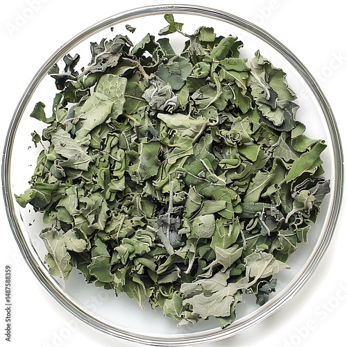 Dehydrated mullein leaves in a glass bowl on a seamless white surface
