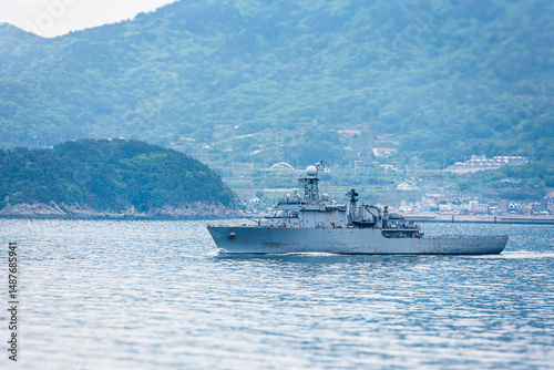 фотографія A South Korean navy frigate in grey camouflage returns to base after a coastal patrol mission near the port of Busan – a quiet moment after completing its maritime duty