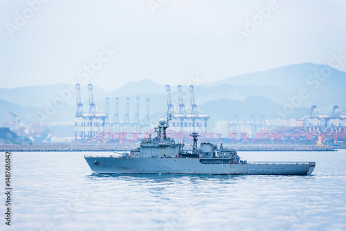 фотографія A South Korean navy frigate in grey camouflage returns to base after a coastal patrol mission near the port of Busan – a quiet moment after completing its maritime duty