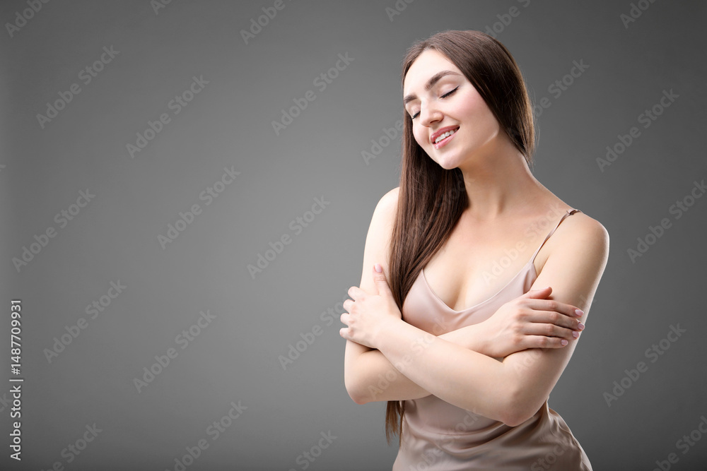Obraz premium Portrait of beautiful woman on grey background. Space for text