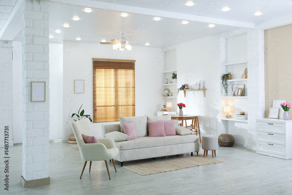 Fototapeta premium Comfortable sofa with cushions in room. Interior design
