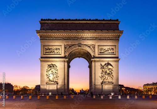 Triumphal arch (Arc de Triomphe) on Charles de Gaulle square at night, Paris, France