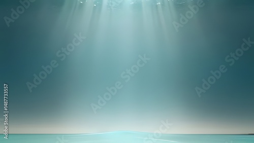 Blue sea water reflects bright sun rays from the soft blue sky