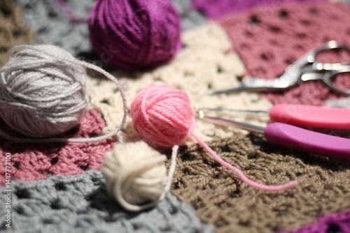 Granny square crocheted blanket with different colors motives, retro vintage craft handmade handiwork crocheting, beautiful plied photo cozy winter or autumn background wool thing yarn lovely warm photo