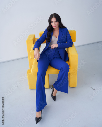 Woman in Blue Suit Sitting on Yellow Chair