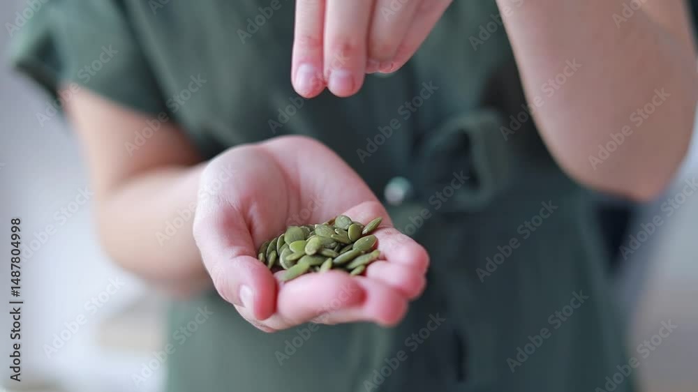 A close-up of a woman s hands holding pumpkin seeds emphasizes their value as a source of antioxidants and healthy fats. Dietetics concept, fitness center.