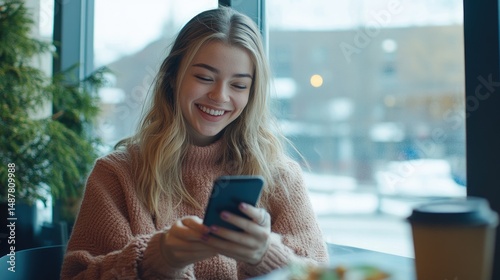 Happy woman using smartphone in cafe.