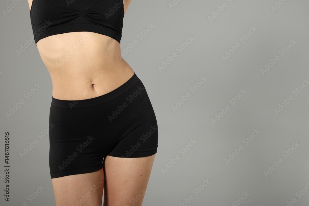 Fototapeta premium Woman with perfect slim body on gray background, closeup. Space for text