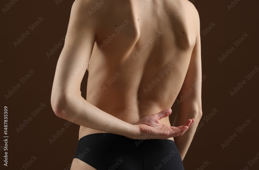 Naklejka premium Woman in panties on brown background, closeup