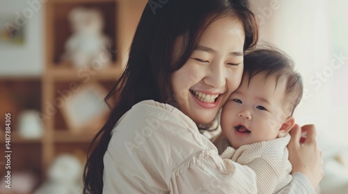 Happy mother embracing her cheerful baby indoors