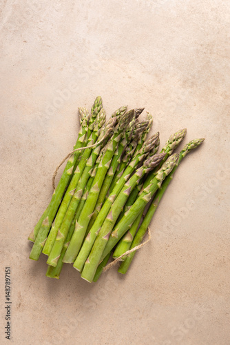 Overhead view of Fresh green asparagus on stone surface