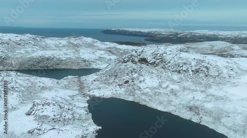 Aerial view showing snow-covered terrain and coastal scenery of Teriberka village on the Kola Peninsula in Russia’s Arctic region.